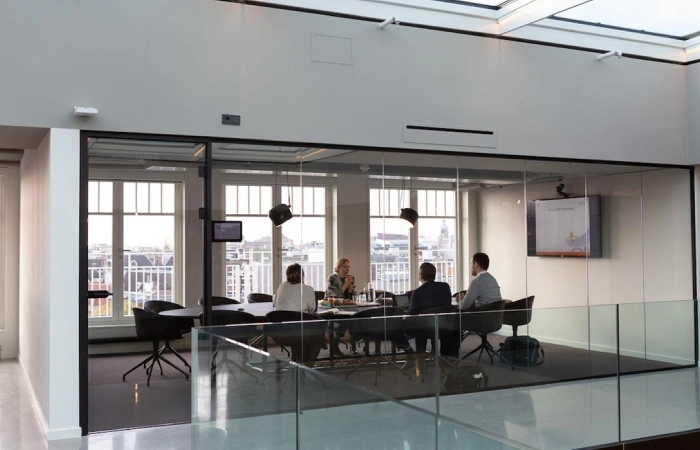 A team sitting at a conference table discussing the importance of client references.